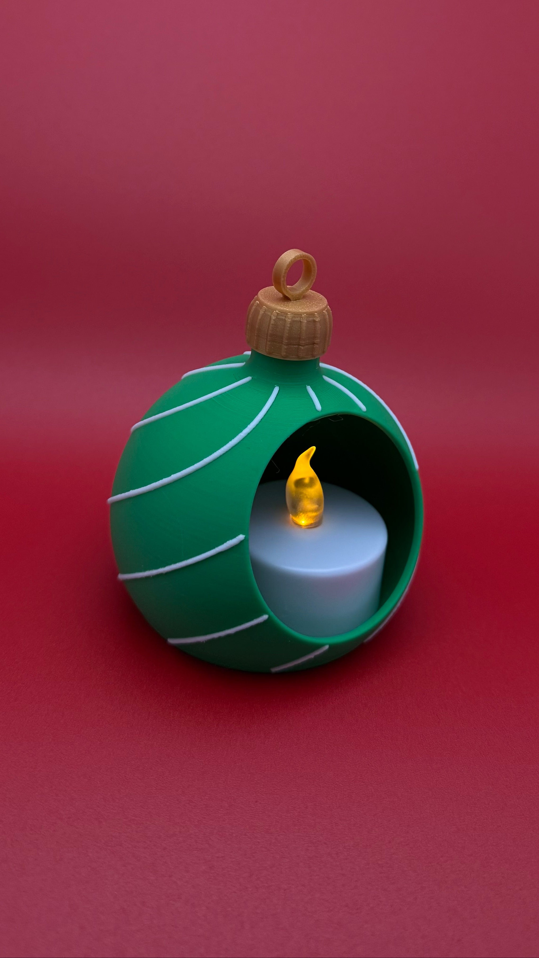 Green ornament with a candle inside on a red background